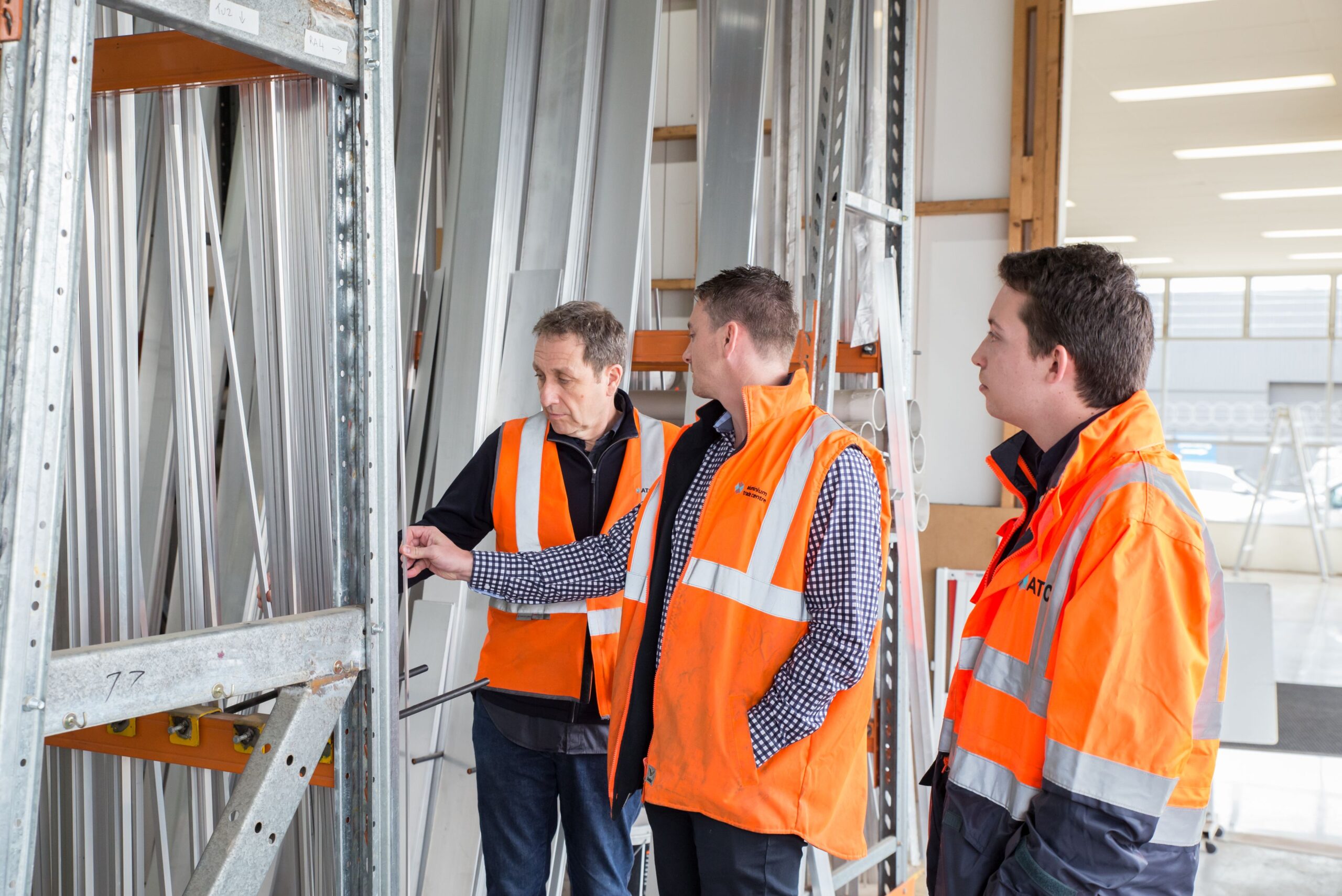 Trois professionnels inspectent ensemble une installation dans un environnement technique